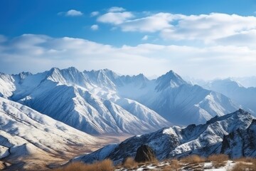 Wall Mural - majestic mountain landscape with snow-covered peaks and blue sky, created with generative ai