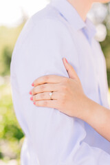 Poster - A woman has her hand on her fiance's arm showing off her engagement ring.
