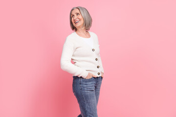 Sticker - Profile portrait of positive friendly aged lady put hands pockets look empty space toothy smile isolated on pink color background