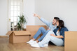 © Prostock-studio - Design Ideas. Couple Sitting On Floor Among Cardboard Boxes In New Flat