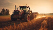 Modern tractor working in a field at sunset, machinery for agriculture harvesting