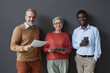 © Seventyfour - Group of successful business people with smiling senior workers looking at camera in office