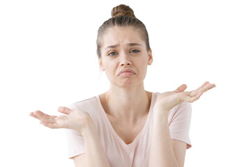 Closeup of emotional young woman isolated on grey background being at a loss, showing helpless gesture with arm and hands, mouth curved as if she does not know what to do with current situation.