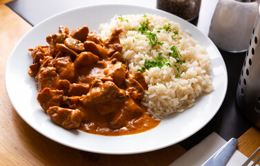 Sticker - Traditional Czech Stroganoff pork tenderloin served with rice and greens..