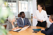 © JackF - Optimistic business partners talking over project sitting around table in large cabinet