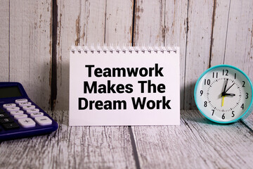 Concept words TMDW Teamwork makes dream work on white note on beautiful wooden background.