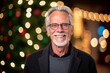 © Robert MEYNER - Portrait of a senior man with glasses against blurred christmas lights