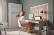 © Mosaic Media - A woman sits in front of her computer, focused intently on her design project.