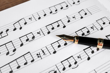 Canvas Print - Sheet with musical notes and fountain pen, closeup view