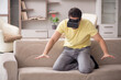 © Elnur - Young man enjoying virtual glasses at home