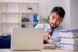 © Elnur - Young male employee speaking by phone at workplace