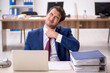 © Elnur - Young male employee working in the office
