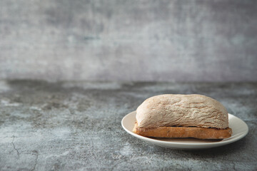 Ciabatta bread on a vintage dark floor