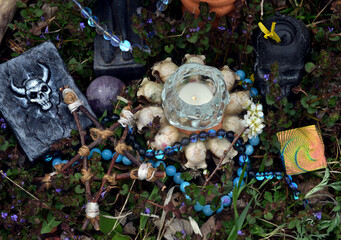 Wall Mural - Magic books with candles, crystals and pentagram on witch altar in the garden. Occult, esoteric and divination still life. Mystic outside background with vintage objects