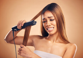 Wall Mural - Woman with flat iron, haircare and heat damage, mistake and worried about hair loss on studio background. Electric straightener, female model with anxiety about keratin treatment fail and hairstyle