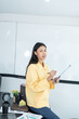 © ND STOCK - Portrait of young asian woman in casual wear holding clipboard, while standing in modern office room.