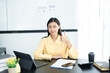 © ND STOCK - Portrait of pretty cheerful girl smiling while working on laptop in office