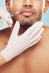 Wall Mural - Skincare, botox and lips with a man in studio on a gray background for a plastic surgery injection. Hands, beauty and syringe with a young male patient indoor for an antiaging facial filler closeup