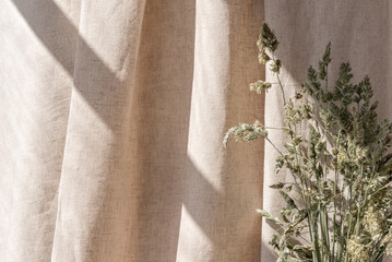 aesthetic boho neutral floral background, abstract sunlight shadows on beige linen curtain and meado