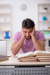 © Elnur - Young male student sitting in the classroom