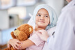 © Alexis Scholtz/peopleimages.com - Cancer patient, child and doctor with support, healthcare service and hand for empathy, love and healing in hospital bed. Happy, sick girl or kid listening to pediatrician or medical person helping