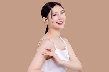 Wall Mural - Close up portrait of attractive beautiful young Asian woman with perfect facial and body skin isolated on brown background. Beauty with cosmetic and surgery concept.