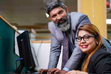 Wall Mural - Indian corporate man and woman working together at office