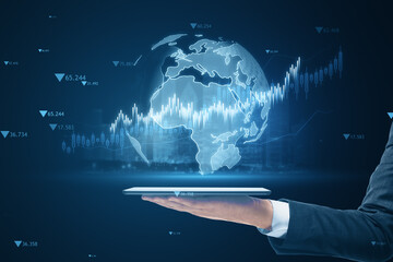 Poster - Close up of male hand holding tablet with creative candlestick forex chart or graph on blue background. Financial trade market and stock concept.