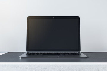 Poster - Close up of empty mock up laptop screen on desktop and concrete wall background. Designer desktop and ad concept. 3D Rendering.