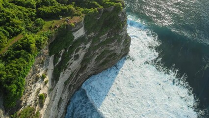 Wall Mural - Aerial view of rocky coastline with cliffs and ocean with waves in Uluwatu, Bali