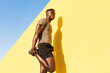 © JustLife - Young man doing stretching exercise outside. African man training outside..