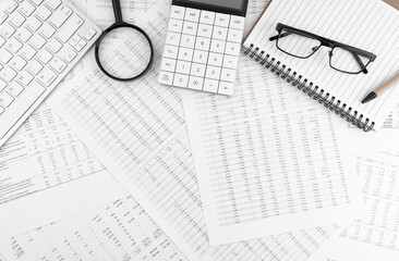 Poster - Calculator, keyboard, magnifying glass, pen, eye glasses lying on financial documents . Financial and business concept. Top view.
