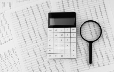 Poster - Calculator and magnifying glass on financial statement. Financial, accounting and business concept.