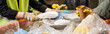 © LIGHTFIELD STUDIOS - Cropped view of workers in protective gloves taking different plastic and paper trash from conveyor while working together in waste disposal station, recycling concept, banner