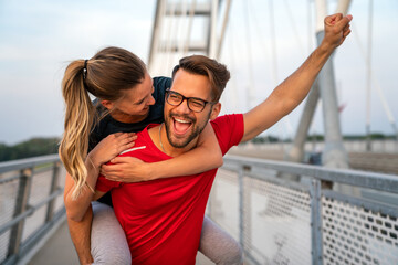 Wall Mural - Romantic couple doing sport together on the street. Having fun after morning run