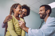 © NDABCREATIVITY - Doctor examines a child with stethoscope in examination room. Healthcare people children concept