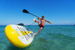 © Aboltin - Tanned sportsman falling to sea water practicing supsurfing with paddle extreme sport leisure