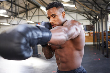 Canvas Print - African man, boxing and punching in gym for fitness, focus or training for growth, goal and health for competition. African guy, boxer and gloves for exercise, wellness or martial arts club for sport