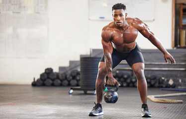 black man, fitness and weightlifting with kettlebell for workout, exercise or training at the gym. a