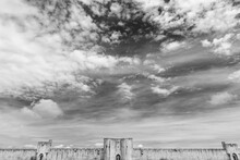 Aigues-Mortes, France. Well Preserved Wall, Ramparts And Towers Of Medieval Town Of  Aigues Mortes Under Beautiful Dramatic Sky With Clouds. Travel  Background. Black White Historic Photo.