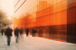 Blurred people in a rush pass in front of a modern building glass wall.