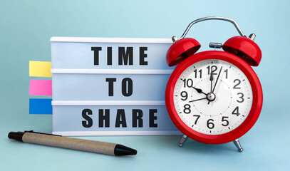 Poster - text time to share written on the lightbox with alarm clock and colorfull stickers on blue backgroun