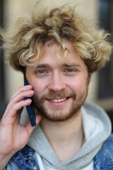 Canvas Print - Curly blonde is talking on the phone.