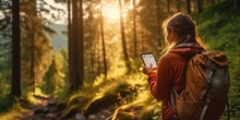 A Smiling Young Woman Relaxing With Backpack Looking At Smart Phone For Navigation While Hiking, Woman Carrying Travel Bags Walking Through A Forest, Generative Ai