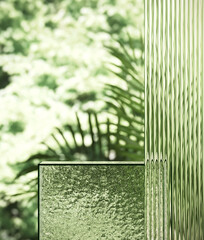 Poster - Minimal style mockup for product presentation. Ribbed glass podium on green garden background. 3d rendering illustration. Clipping path of each element included.