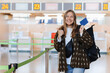 Travelling, vacation, tourism concept. Positive attractive young woman showing passport and thumb up at public airport terminal after check in, smiling at camera, gesturing like, carrying backpack.