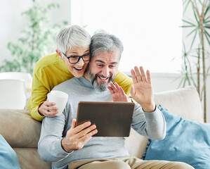 Wall Mural - woman couple senior man happy internet love tablet call video communication online internet mature active elderly retirement computer technology online using  talking video call connection home