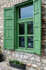 Wall Mural - Green wooden shutters of an old cottage. protects the windows close with double doors