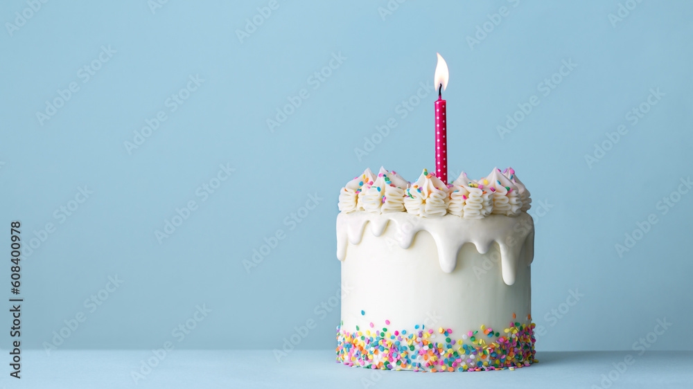 Celebration birthday cake with white drip icing and colorful sprinkles ...