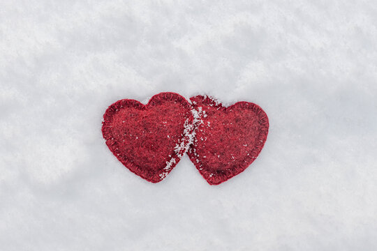 Wall Mural - cute red hearts together on white fluffy snow, love concept, valentines day card.